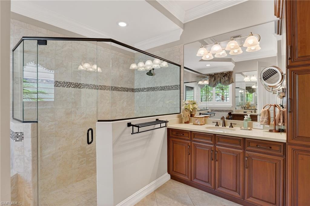 7352 Lantana Way Naples, FL 34119 - Photo 23 of 48 a bathroom with a double vanity sink mirror and shower