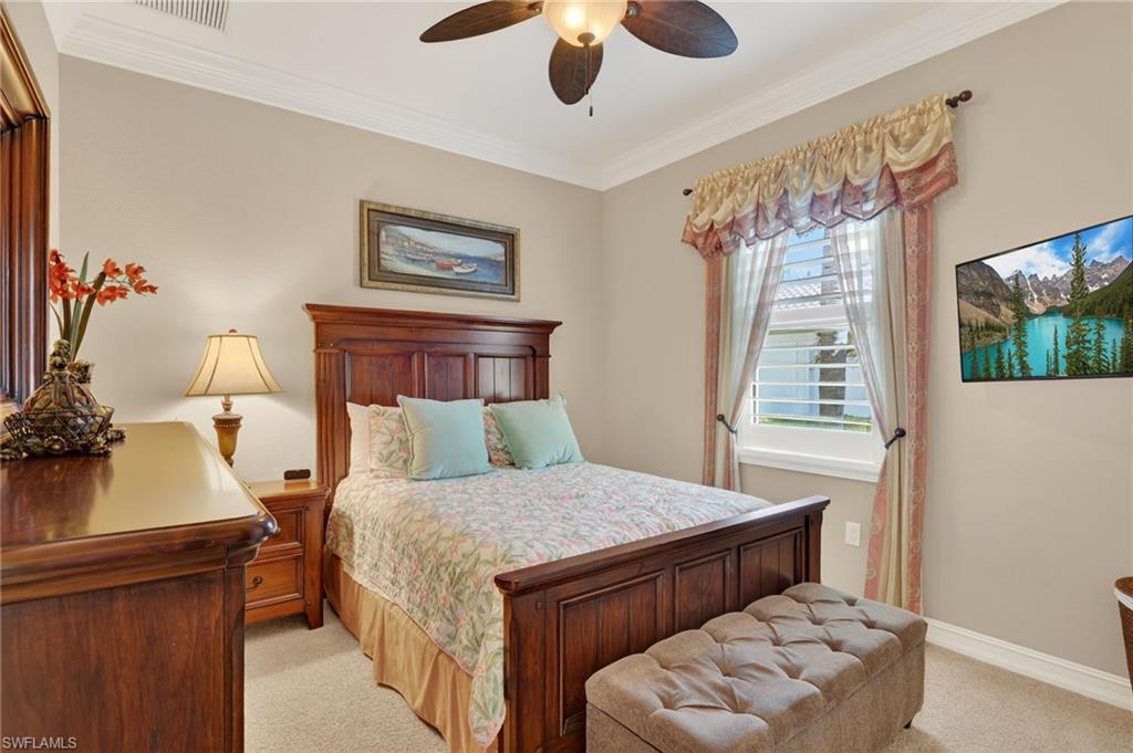 7352 Lantana Way Naples, FL 34119 - Photo 29 of 48 a bedroom with a bed and wooden floor