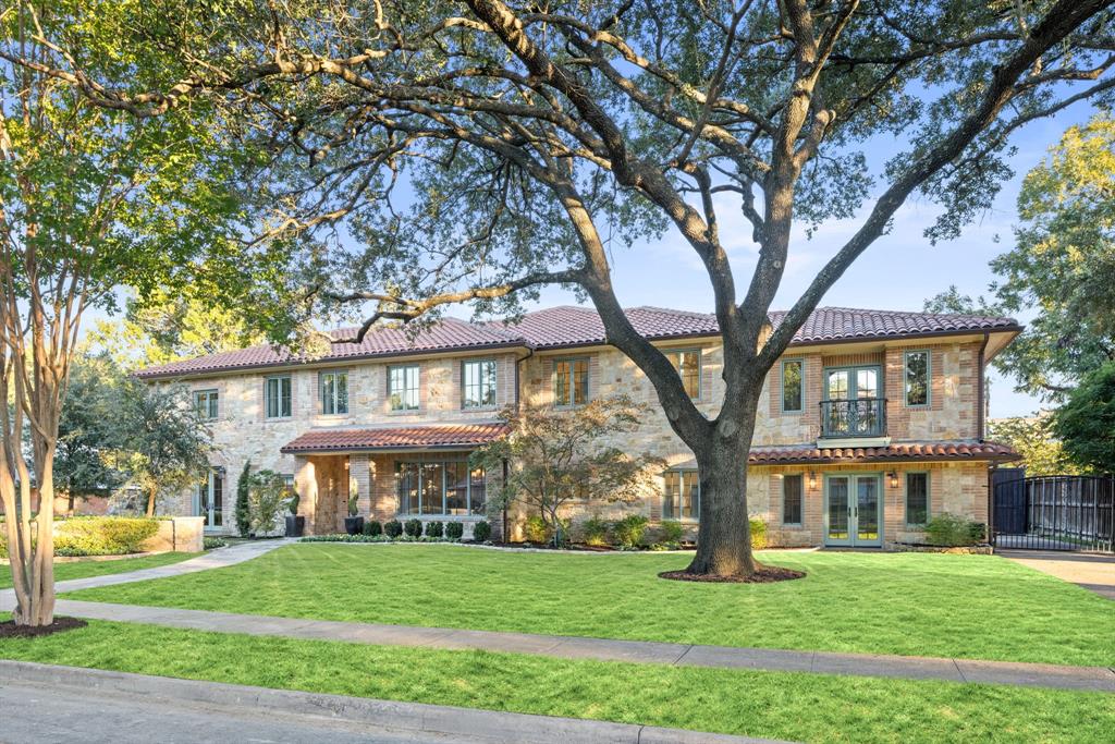7130 Brookcove Lane Dallas, TX 75214 - Photo 39 of 40 a view of a big yard in front of a brick house with large windows