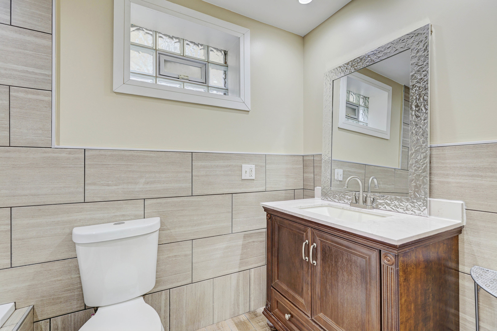 5040 West Berenice Avenue, Unit 1 Chicago, IL 60641 - Photo 11 of 18 a bathroom with a toilet sink and mirror