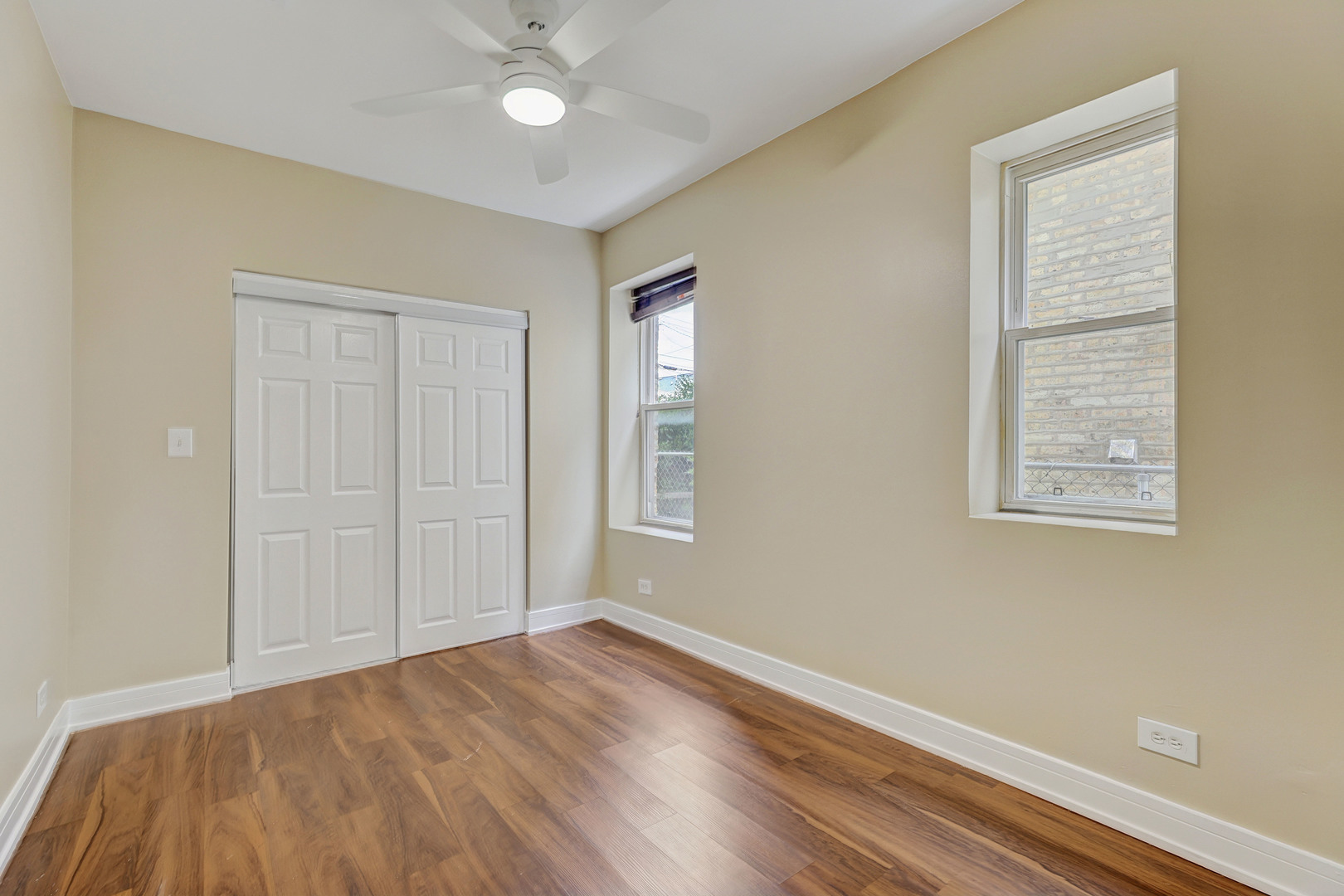 5040 West Berenice Avenue, Unit 1 Chicago, IL 60641 - Photo 12 of 18 wooden floor in an empty room with a window