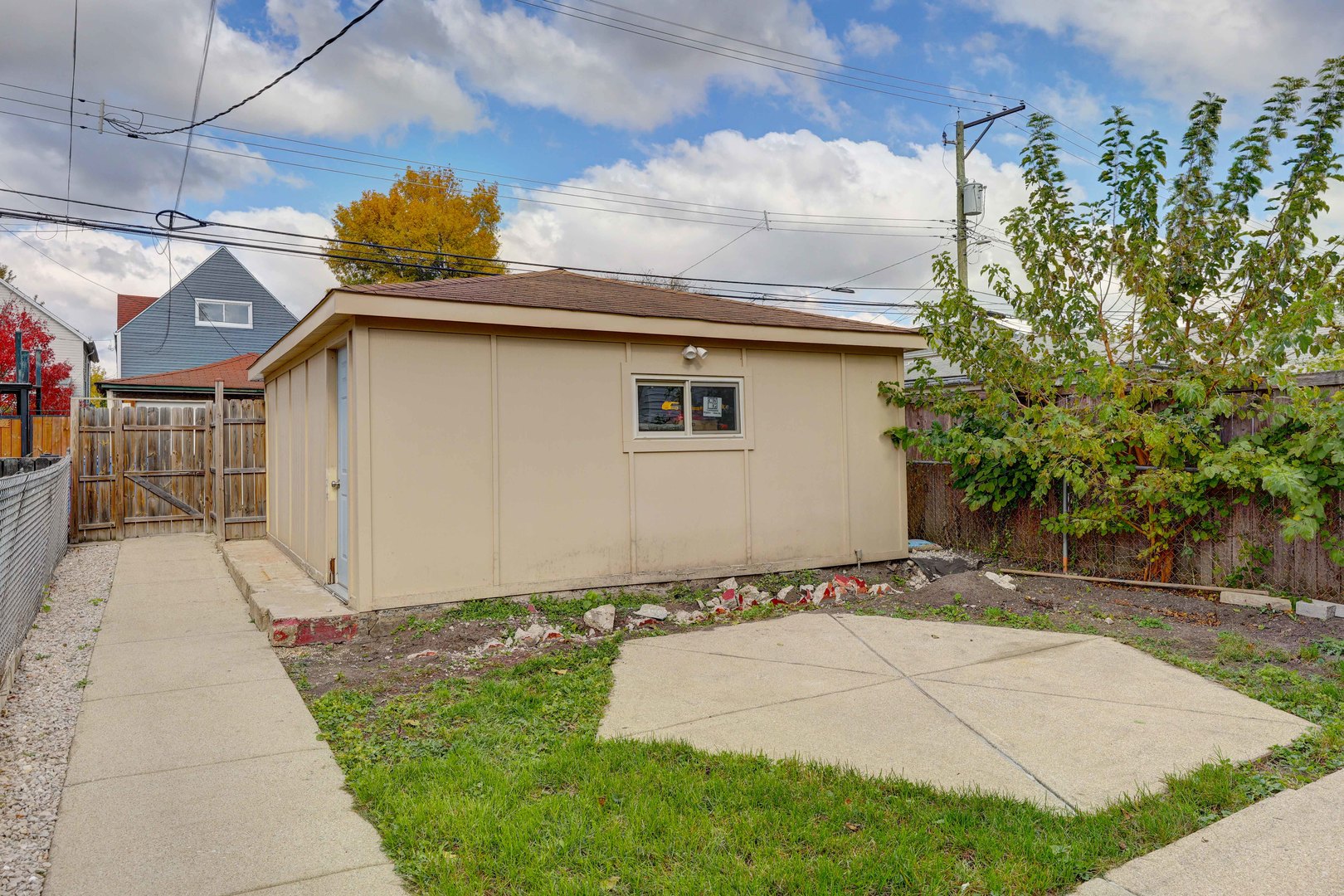 5040 West Berenice Avenue, Unit 1 Chicago, IL 60641 - Photo 17 of 18 a white house with tree in front of it
