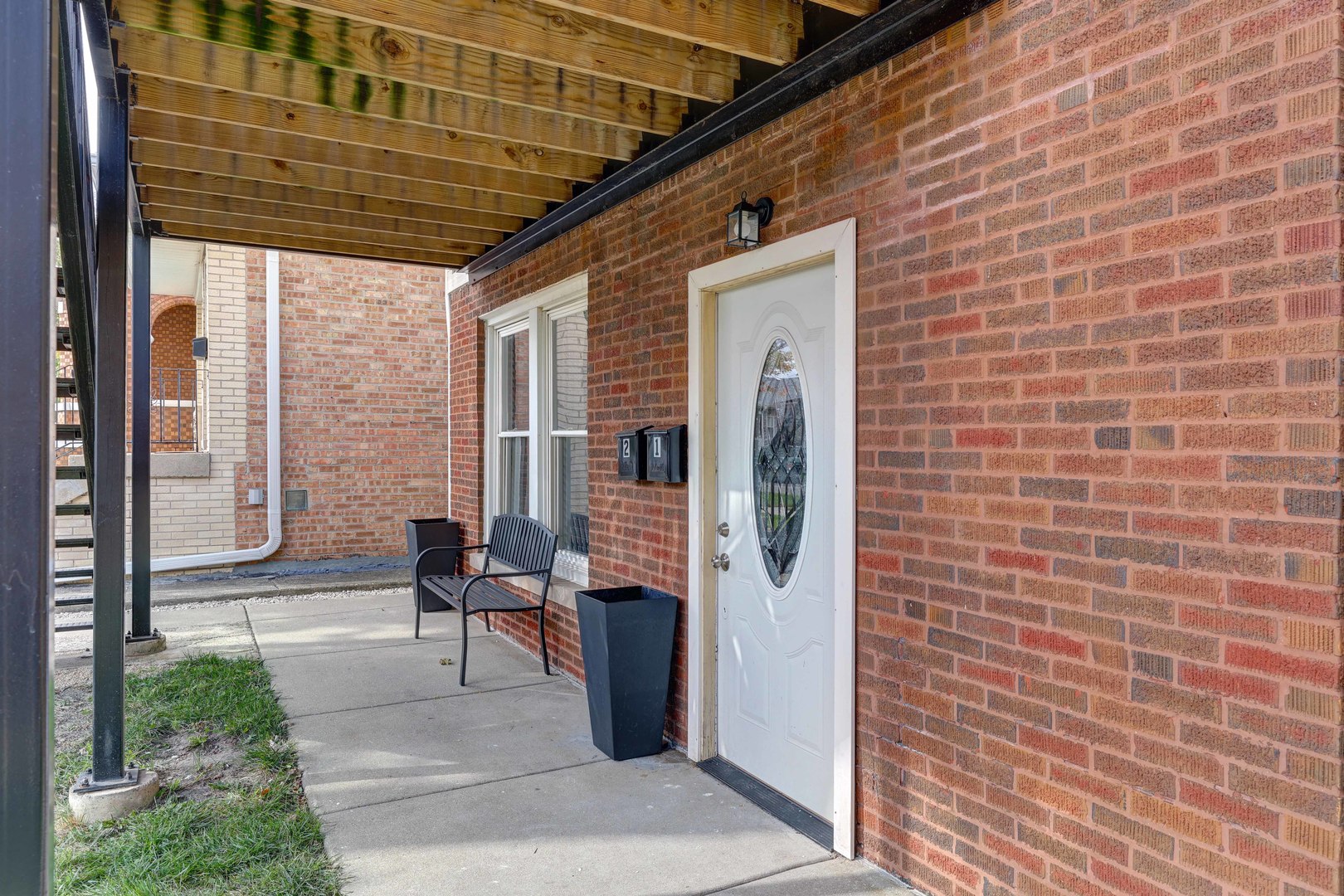 5040 West Berenice Avenue, Unit 1 Chicago, IL 60641 - Photo 3 of 18 a front view of a house with outdoor seating