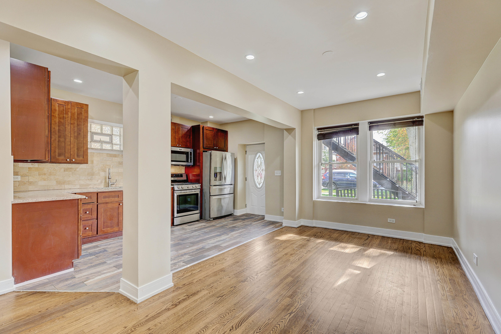 5040 West Berenice Avenue, Unit 1 Chicago, IL 60641 - Photo 10 of 18 a view of a livingroom with a dinning area hardwood and a kitchen