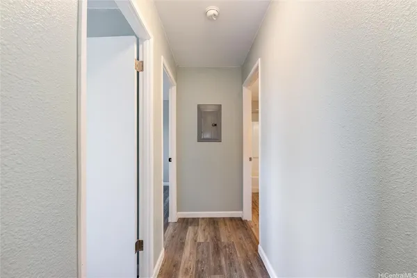 a view of a hallway with wooden floor