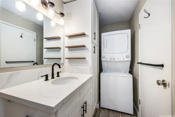 a bathroom with a sink and mirror with toilet