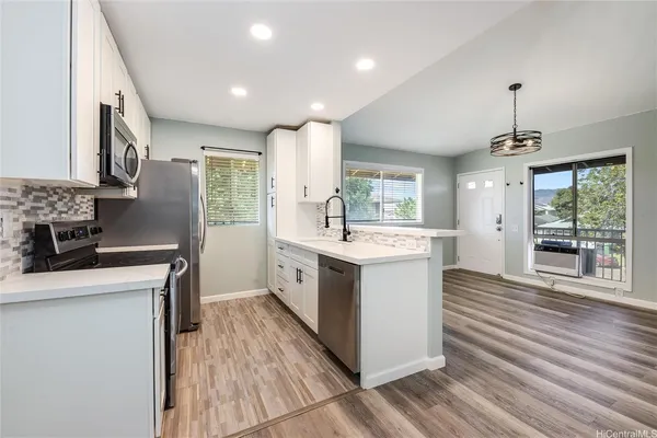 a kitchen with a sink stove and cabinets