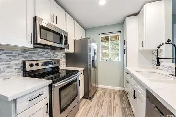 a kitchen with a stove microwave and sink