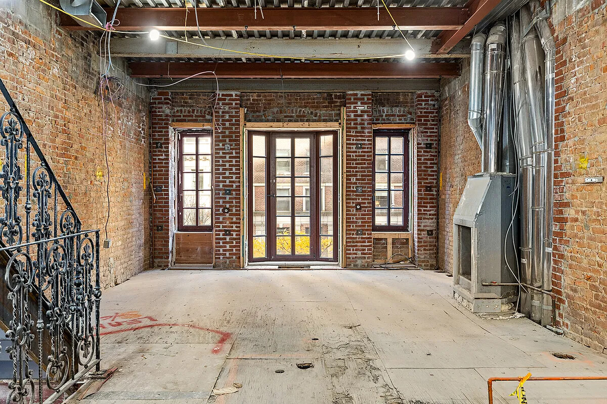 212 East 72nd Street Manhattan, NY 10021 - Photo 7 of 16 a view of an empty room with wooden floor and a window