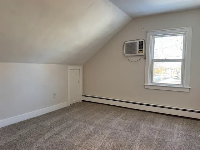 a view of an empty room with closet area