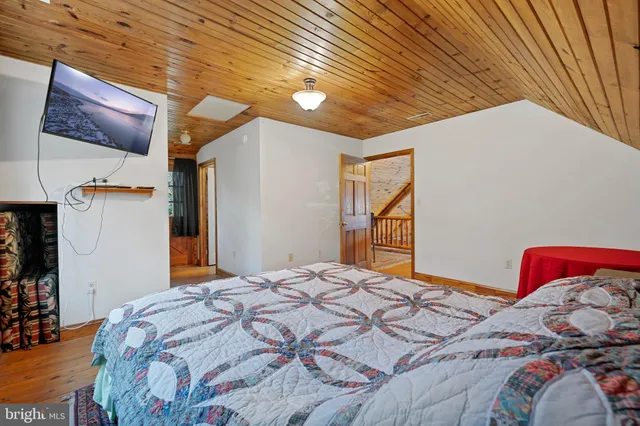 a bathroom with a sink a toilet a mirror and shower