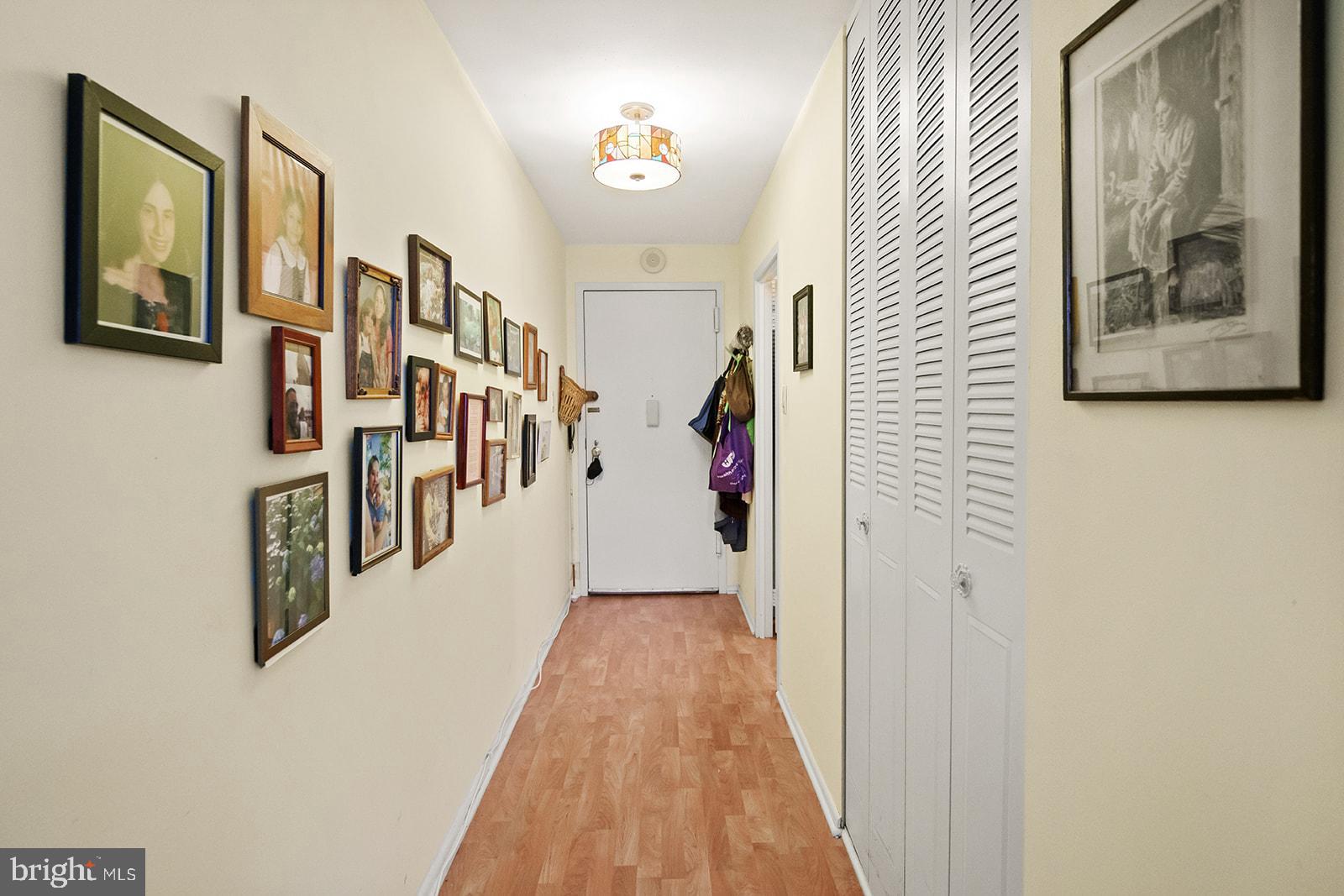 a view of a hallway with wooden floor and stairs