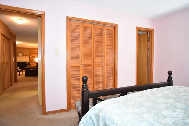 a bedroom with a bed and a mirror