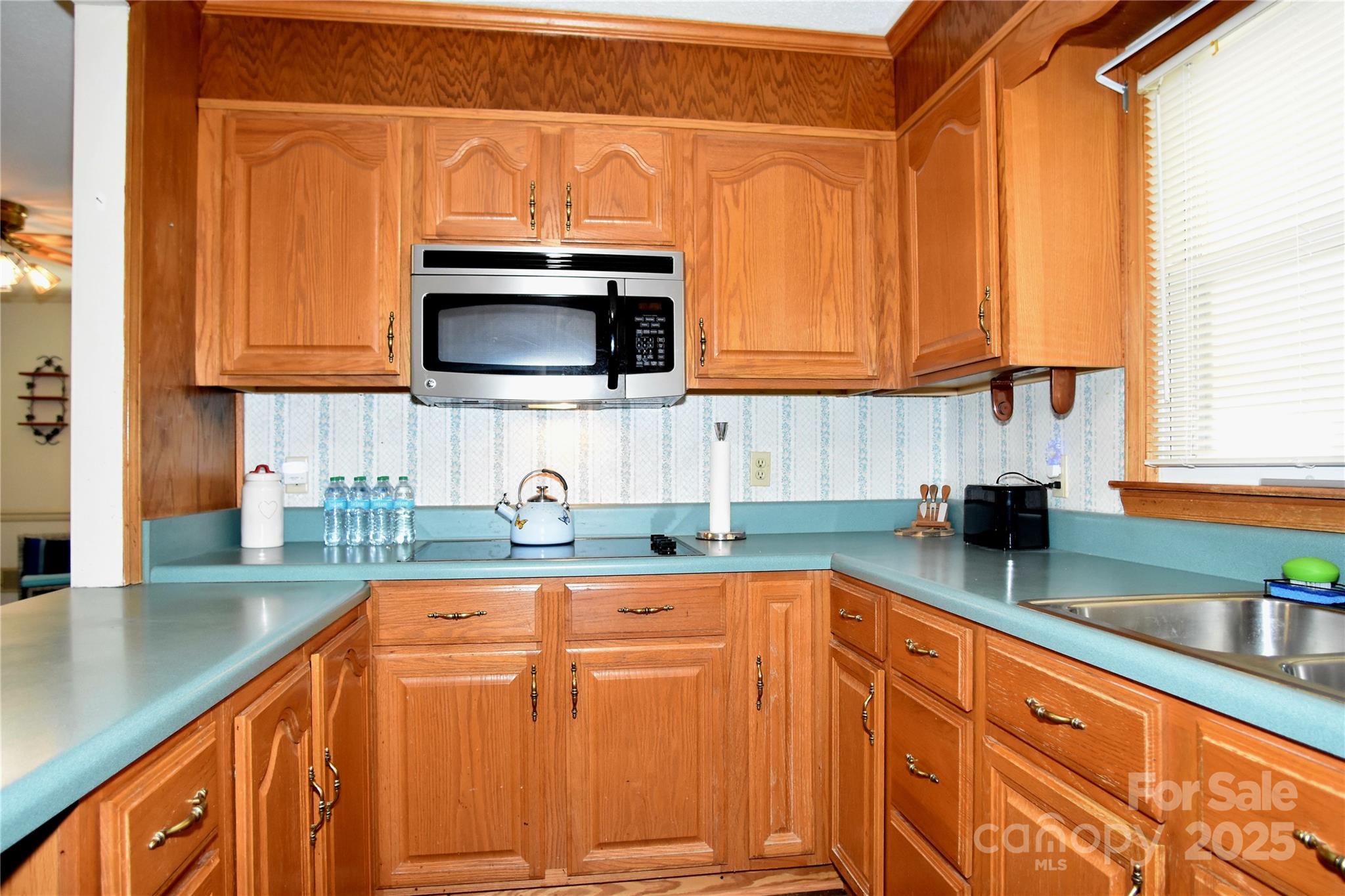 802 Linden Drive Chester, SC 29706 - Photo 20 of 47 a kitchen with granite countertop a sink a stove and cabinets