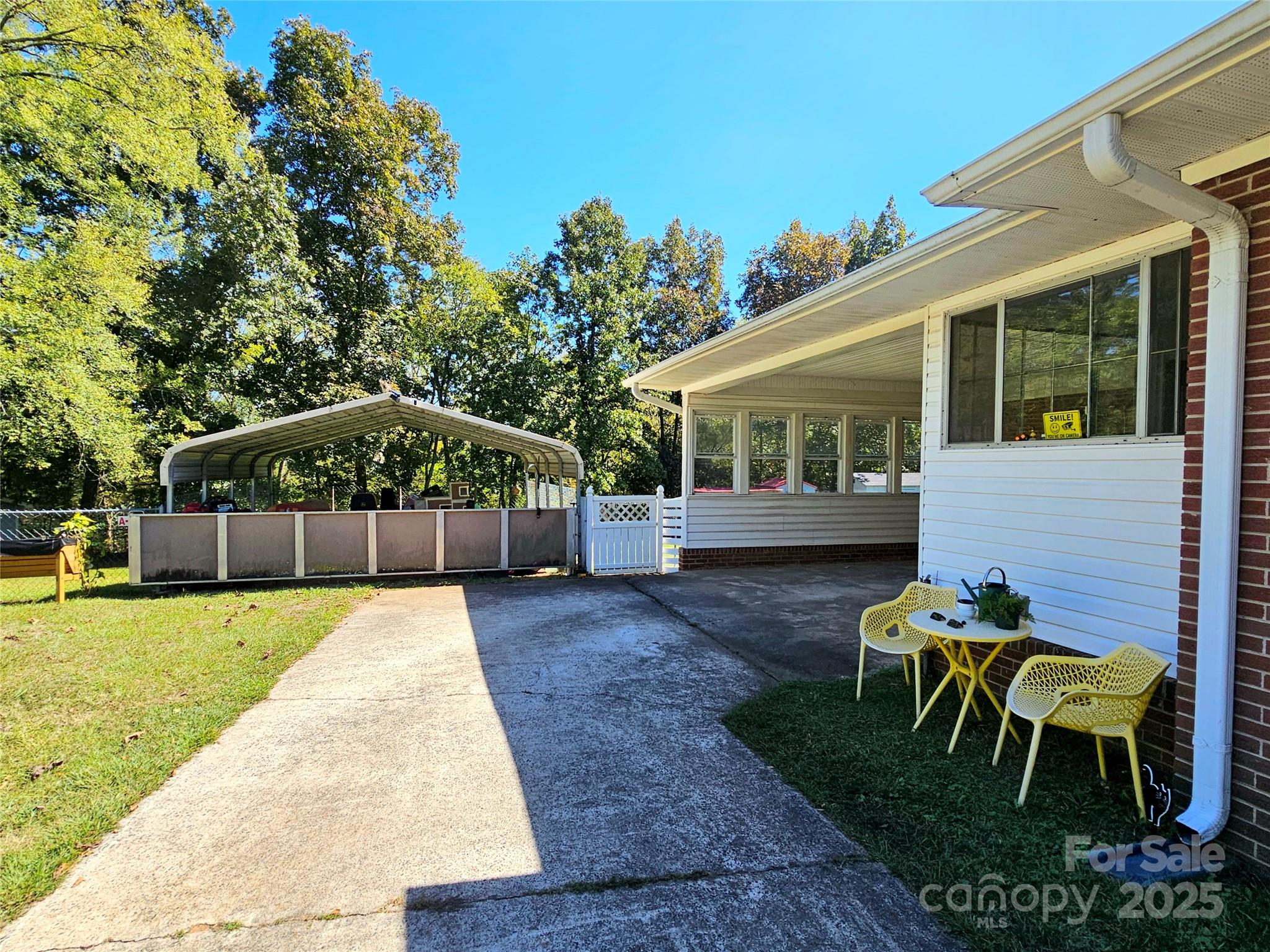 802 Linden Drive Chester, SC 29706 - Photo 26 of 47 a view of a patio with table and chairs under an umbrella