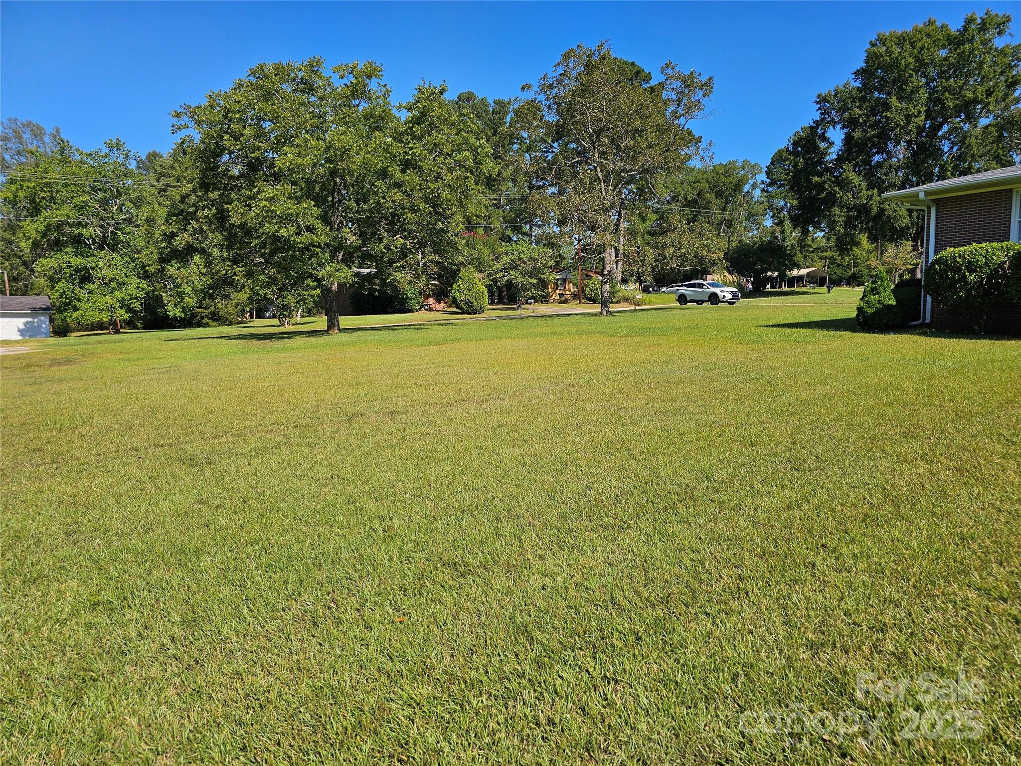 802 Linden Drive Chester, SC 29706 - Photo 31 of 47 a view of a green field with trees in the background