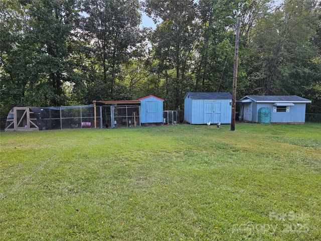 a view of a house with yard and sitting area