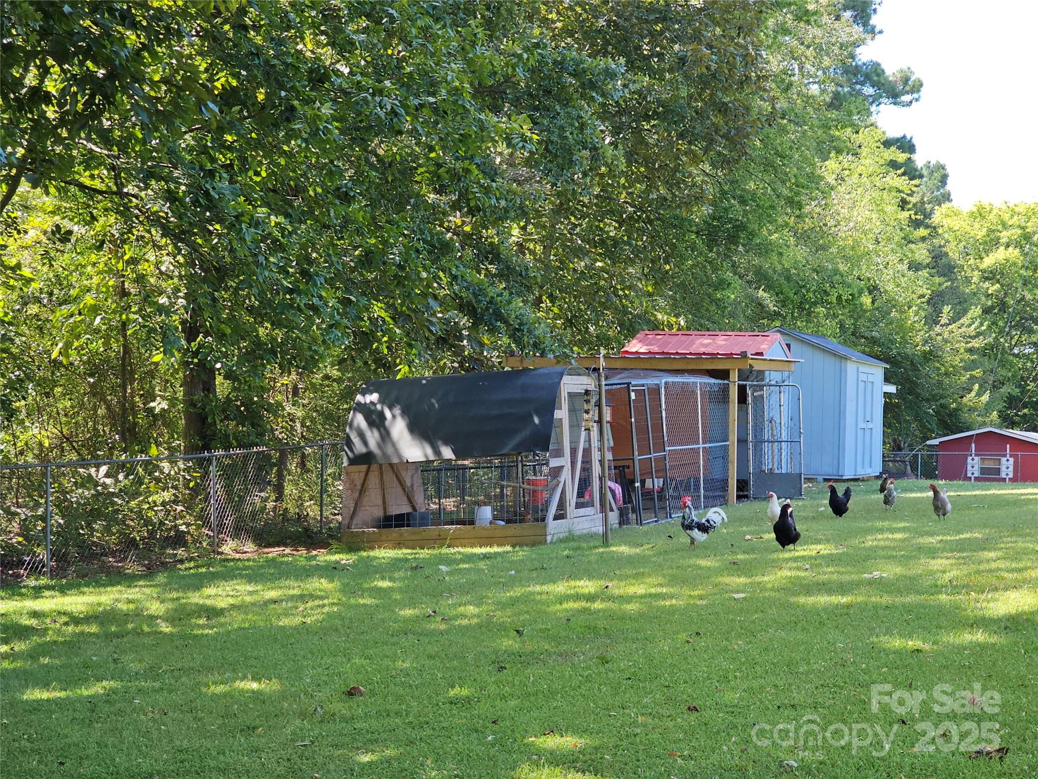 802 Linden Drive Chester, SC 29706 - Photo 41 of 47 a backyard of a house with childrens swings and slides