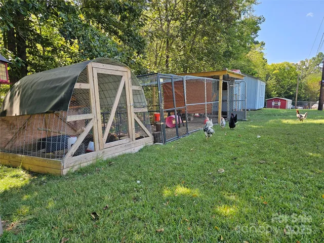 a view of a house with a yard and sitting area
