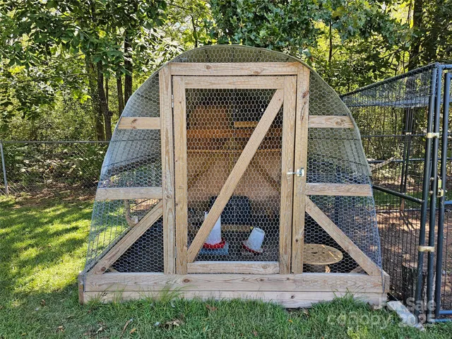 a view of small house with backyard