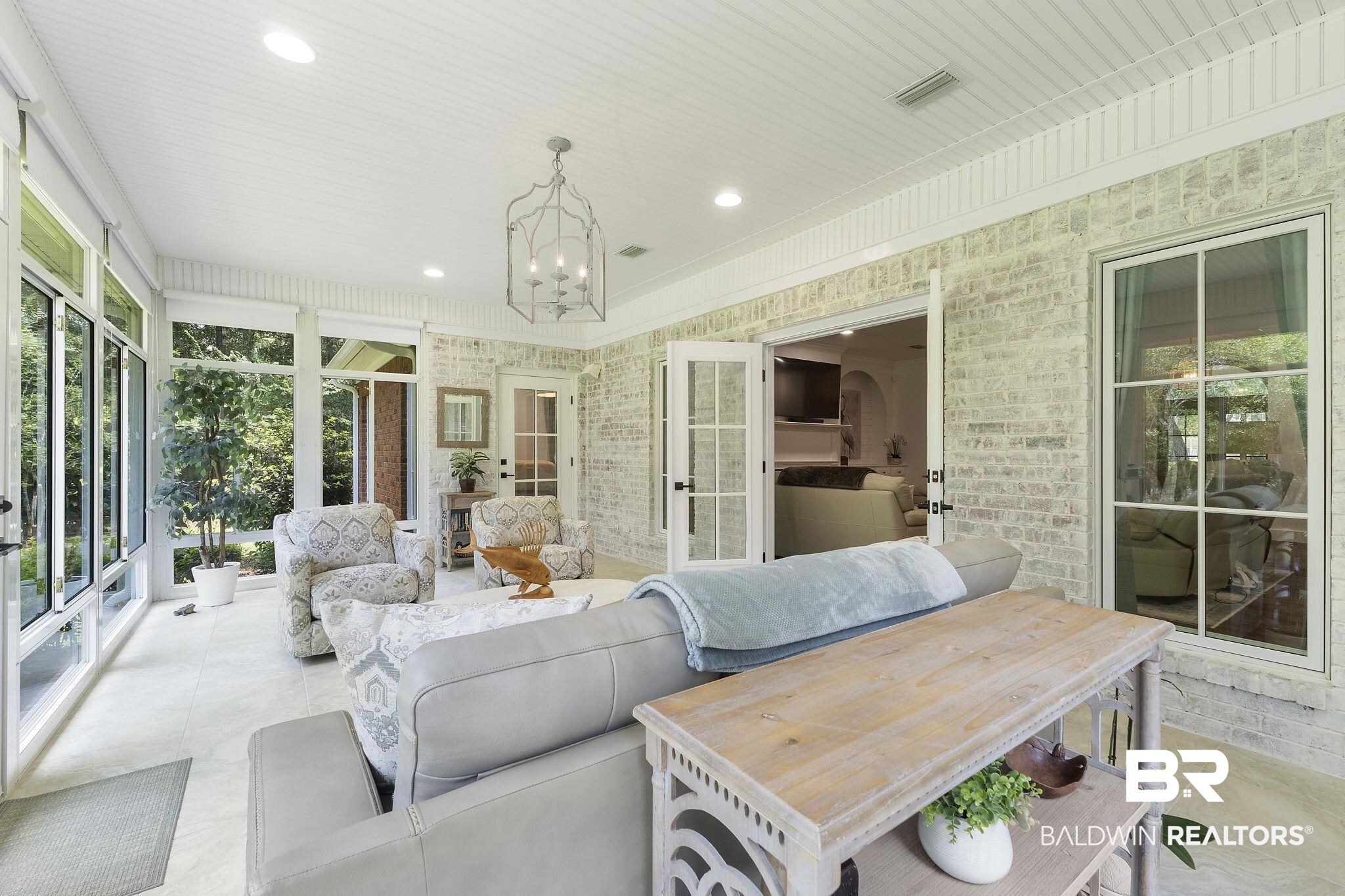 4451 Millhouse Road Gulf Shores, AL 36542 - Photo 13 of 50 Sunroom featuring a notable chandelier and french doors