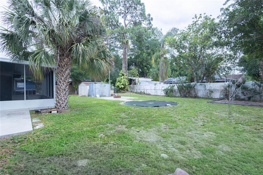 314 4th Avenue Southwest Ruskin, FL 33570 - Photo 21 of 30 a view of backyard with table and outdoor seating