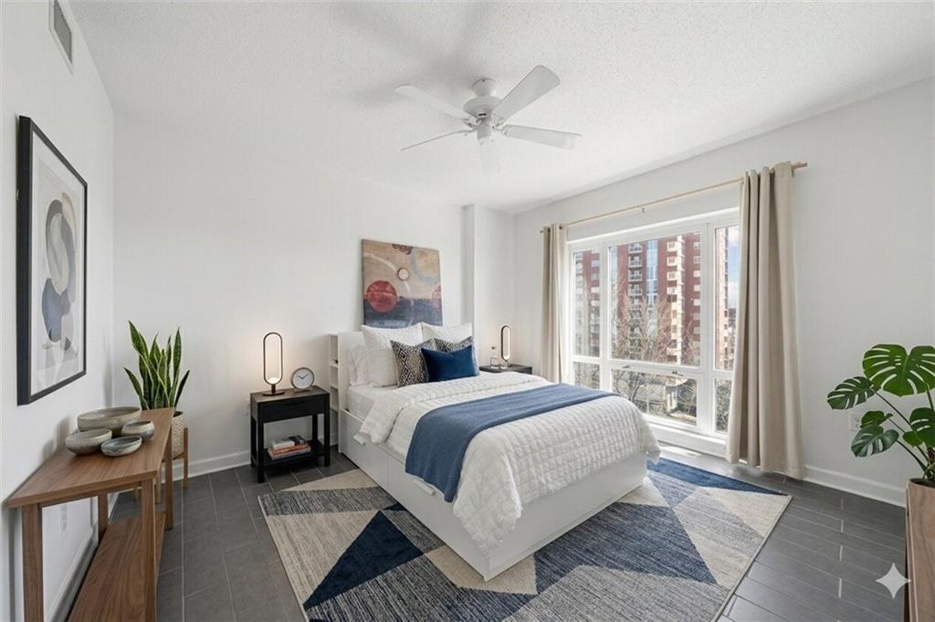3475 Oak Valley Road Northeast, Unit 410 Atlanta, GA 30326 - Photo 16 of 36 a bedroom with a bed and a potted plant