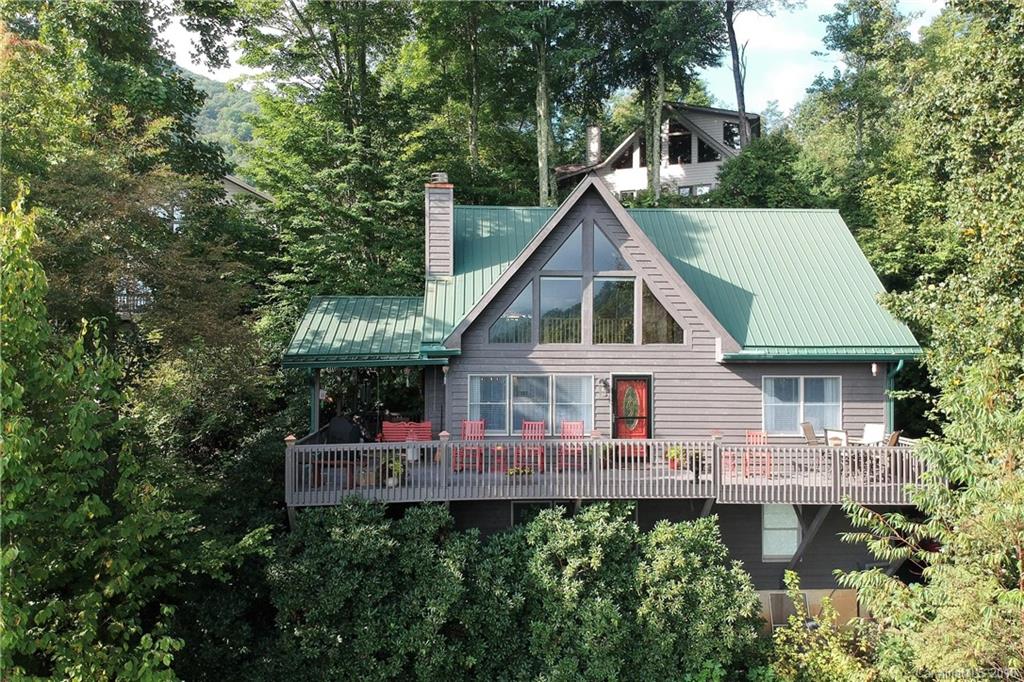 204 Kings Ridge Road Maggie Valley, NC 28751 - Photo 1 of 34 a view of a house with roof deck and sitting area