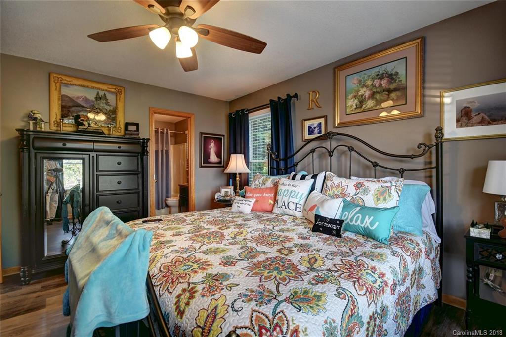 204 Kings Ridge Road Maggie Valley, NC 28751 - Photo 12 of 34 a bedroom with a bed and wooden floor
