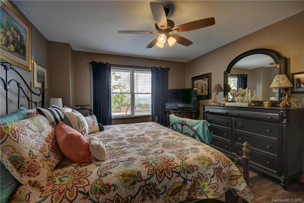 204 Kings Ridge Road Maggie Valley, NC 28751 - Photo 13 of 34 a bedroom with a bed and a dresser