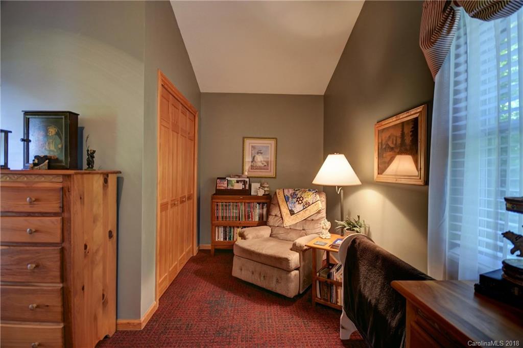 204 Kings Ridge Road Maggie Valley, NC 28751 - Photo 19 of 34 a bedroom with a bed and wooden floor