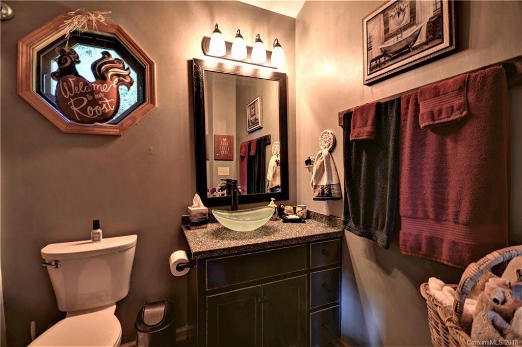 204 Kings Ridge Road Maggie Valley, NC 28751 - Photo 20 of 34 a bathroom with a toilet sink and mirror