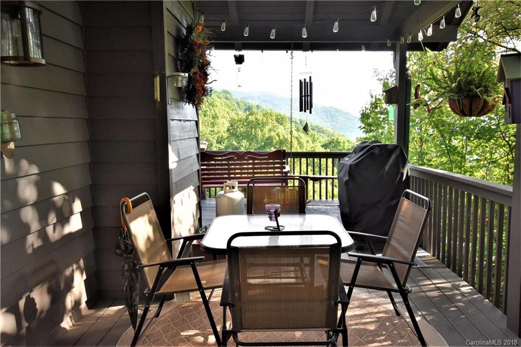 204 Kings Ridge Road Maggie Valley, NC 28751 - Photo 3 of 34 a view of a chairs and table in patio