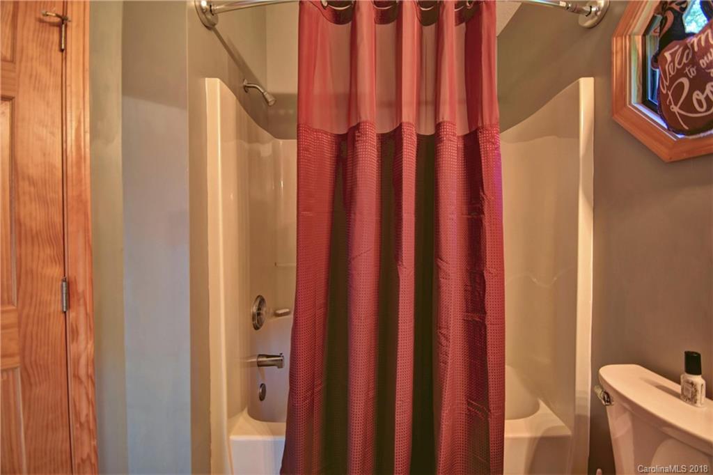 204 Kings Ridge Road Maggie Valley, NC 28751 - Photo 21 of 34 a bathroom with a shower curtain and a window