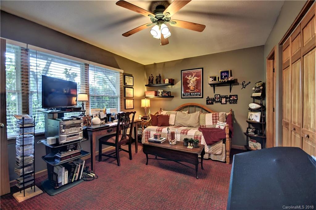 204 Kings Ridge Road Maggie Valley, NC 28751 - Photo 22 of 34 a living room with furniture and a flat screen tv
