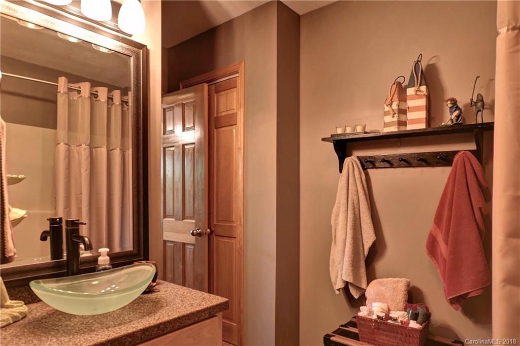 204 Kings Ridge Road Maggie Valley, NC 28751 - Photo 23 of 34 a bathroom with a sink and a mirror