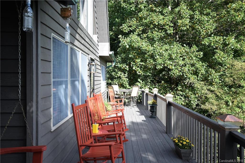 204 Kings Ridge Road Maggie Valley, NC 28751 - Photo 4 of 34 a view of balcony with wooden floor and outdoor seating