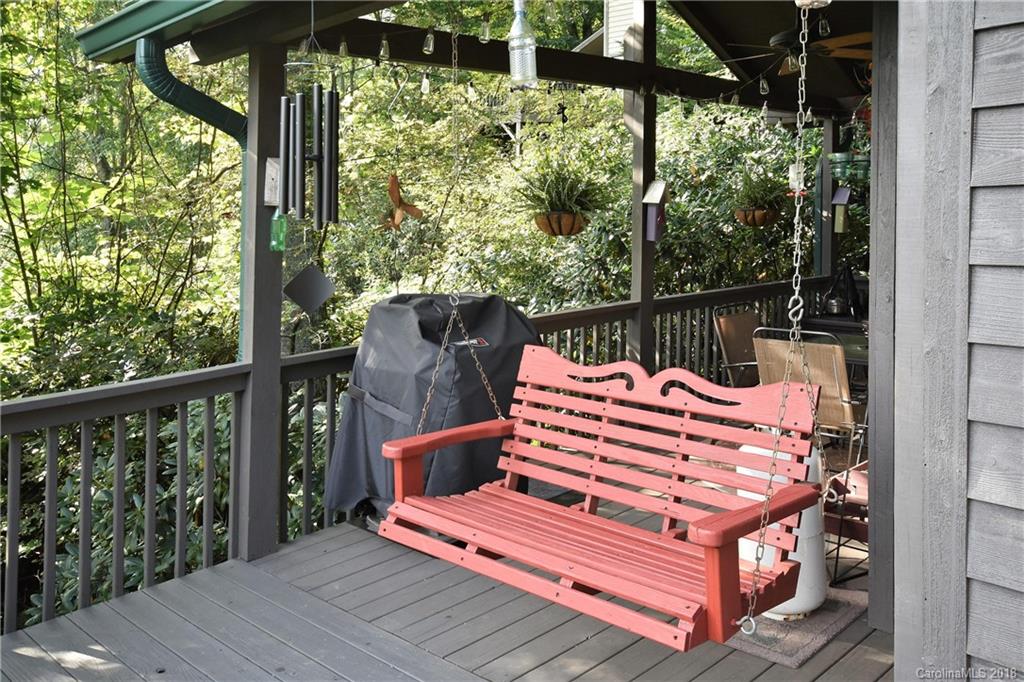 204 Kings Ridge Road Maggie Valley, NC 28751 - Photo 5 of 34 a view of a wooden deck with a bench