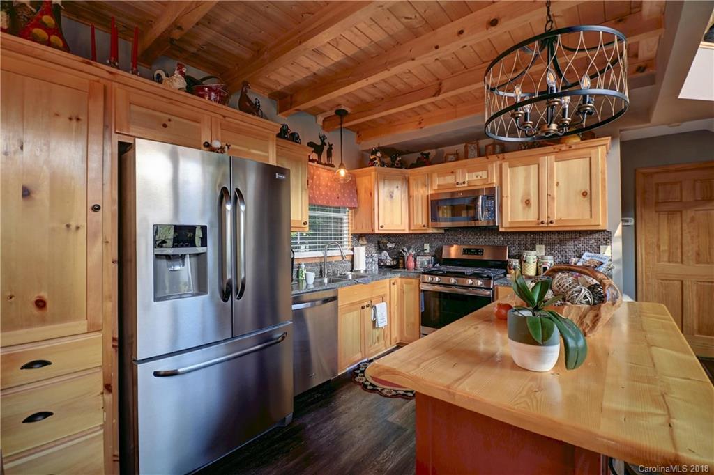 204 Kings Ridge Road Maggie Valley, NC 28751 - Photo 9 of 34 a kitchen with a refrigerator and a sink
