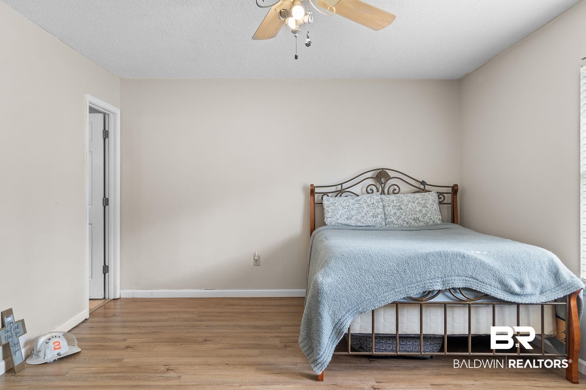 33135 Collier Road Lillian, AL 36549 - Photo 16 of 30 Bedroom with light wood-type flooring, a ceiling fan, and a textured ceiling