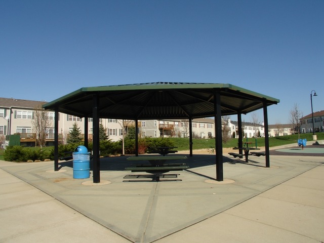 2408 Golf Ridge Circle Naperville, IL 60563 - Photo 23 of 25 a view of patio with a table and chairs under an umbrella