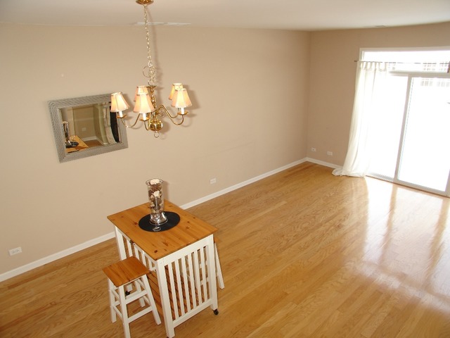 2408 Golf Ridge Circle Naperville, IL 60563 - Photo 7 of 25 a room with wooden floor and white walls