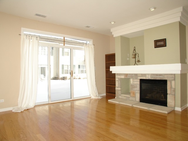 2408 Golf Ridge Circle Naperville, IL 60563 - Photo 8 of 25 a view of an empty room with kitchen and fireplace