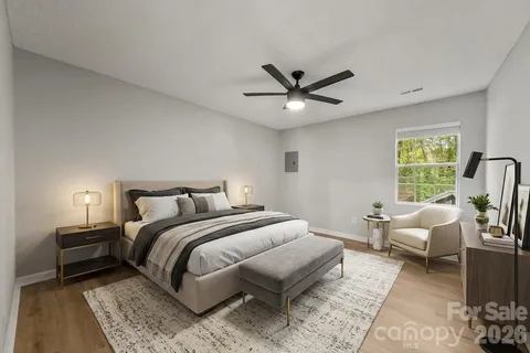 a bedroom with a bed couch and a window