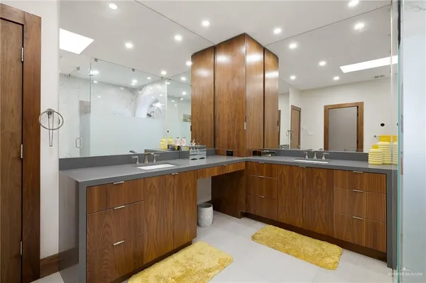 a bathroom with a sink a large mirror and a shower