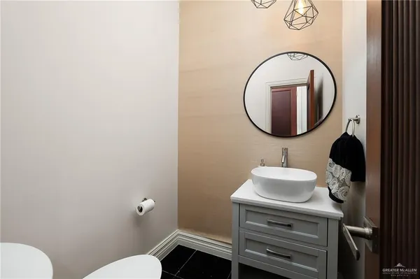 a bathroom with a sink toilet and mirror