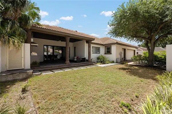 a view of a house with swimming pool and sitting area