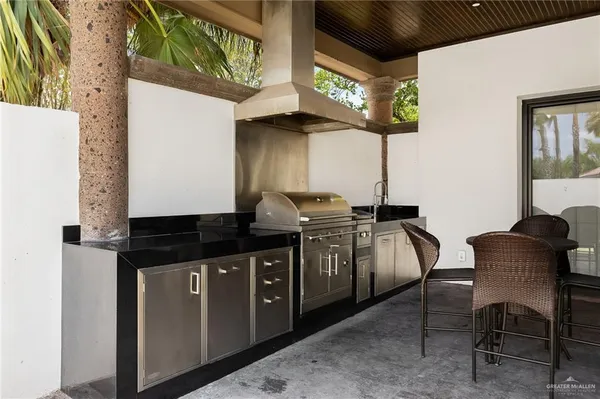 a kitchen with stainless steel appliances granite countertop a sink and a stove