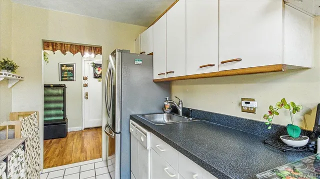 a kitchen with stainless steel appliances granite countertop a sink and a refrigerator