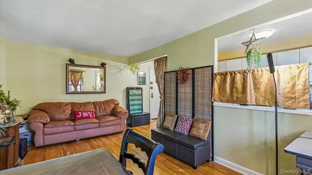a living room with furniture a rug and a wall painting